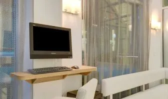 Business center with computer, printer and comfortable seating at Wyndham Garden Brooklyn Sunset Park.