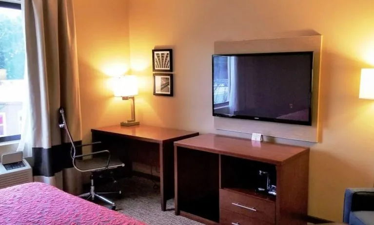 Day use room' workspace with TV screen, work desk and ergonomic chair at Days Inn By Wyndham Brooklyn Marine Park.