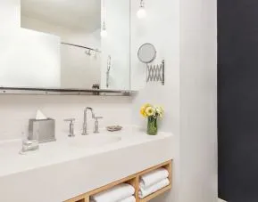 Private guest bathroom with shower and free toiletries at Nu Hotel - Brooklyn.