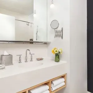 Private guest bathroom with shower and free toiletries at Nu Hotel - Brooklyn.