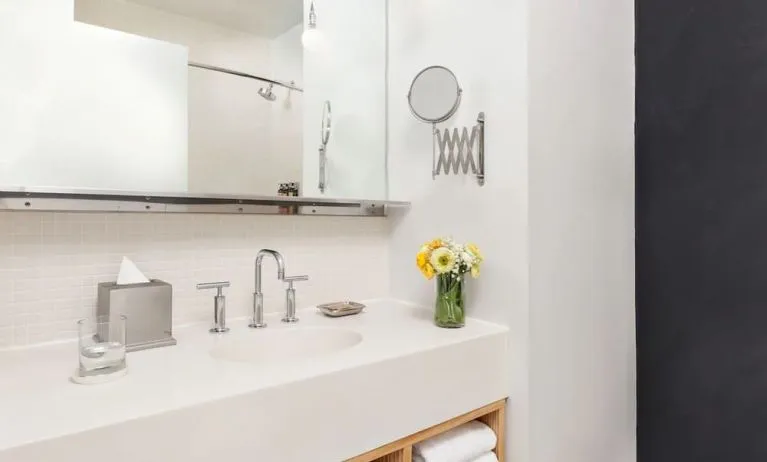 Private guest bathroom with shower and free toiletries at Nu Hotel - Brooklyn.