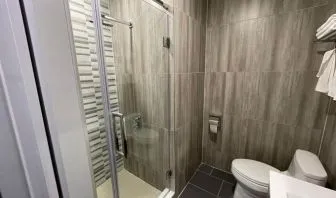 Private bathroom with shower at King Hotel Brooklyn.