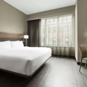 Standard day use room with king bed, large windows, work desk and private bathroom at AC Hotel New York Times Square.