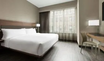 Standard day use room with king bed, large windows, work desk and private bathroom at AC Hotel New York Times Square.