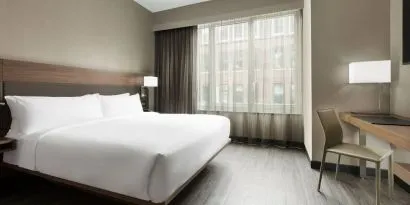 Standard day use room with king bed, large windows, work desk and private bathroom at AC Hotel New York Times Square.