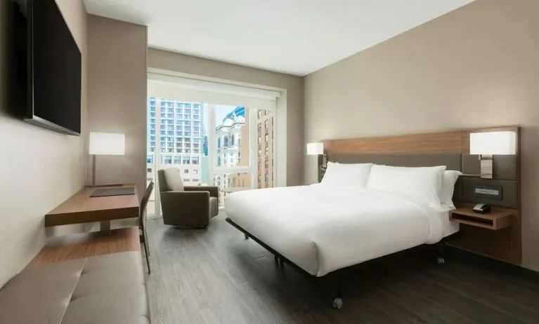 Day use room with workspace, large windows and private bathroom at AC Hotel New York Times Square.