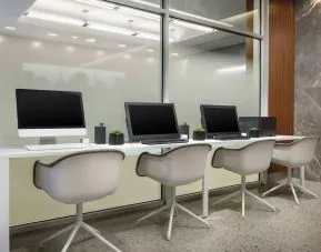 Business center with cmputers, printer and ergonomic chairs at AC Hotel New York Times Square.