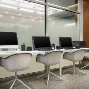 Business center with cmputers, printer and ergonomic chairs at AC Hotel New York Times Square.