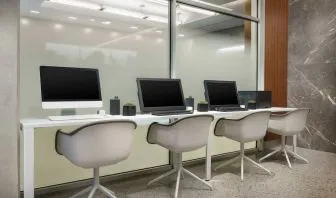 Business center with cmputers, printer and ergonomic chairs at AC Hotel New York Times Square.