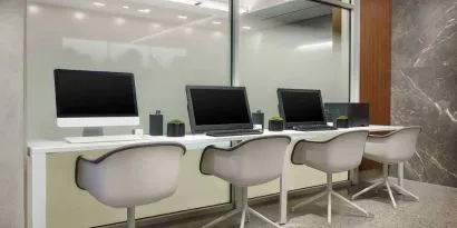 Business center with cmputers, printer and ergonomic chairs at AC Hotel New York Times Square.