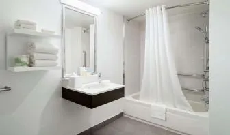 Private guest bathroom with combine shower and tub at Hampton Inn Manhattan Chelsea.