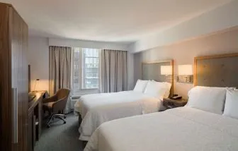 Day use twin room with work desk, large windows and private bathroom at Hampton Inn Manhattan Chelsea.