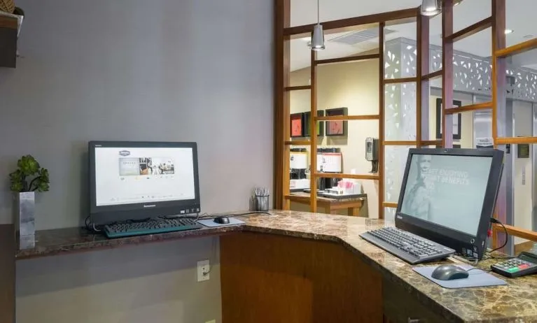 Business center with computers and printer at Hampton Inn Manhattan Chelsea.