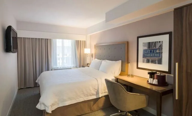 Day use room with king bed, work desk, natural light and private bathroom at Hampton Inn Manhattan - Madison Square Garden.