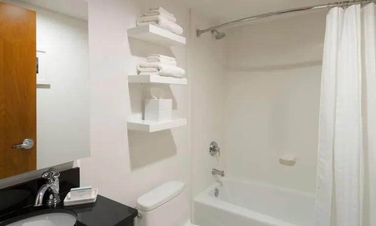 Private guest bathroom with combined shower and tub at Hampton Inn Manhattan - Madison Square Garden.