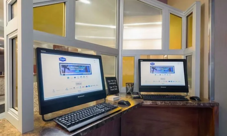 Business center with computers and printer at Hampton Inn Manhattan - Madison Square Garden.