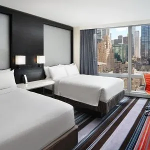 Day use twin room with work desk and floor to ceiling window at Courtyard By Marriott New York Manhattan/Central Park.