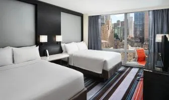 Day use twin room with work desk and floor to ceiling window at Courtyard By Marriott New York Manhattan/Central Park.