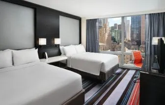 Day use twin room with work desk and floor to ceiling window at Courtyard By Marriott New York Manhattan/Central Park.