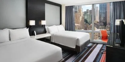 Day use twin room with work desk and floor to ceiling window at Courtyard By Marriott New York Manhattan/Central Park.