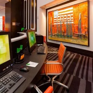 Business center with computers, printer and ergonomic chairs at Courtyard By Marriott New York Manhattan/Central Park.