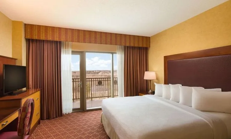 Day use room with balcony and work desk at Embassy Suites By Hilton Charlotte-Concord-Golf Resort & Spa.
