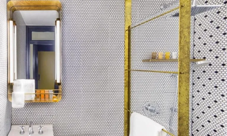 Private guest bathroom with shower and free toiletries at Hotel Shocard NYC.
