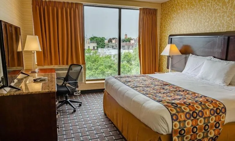 Day use room with king bed, work desk, large windows and private bathroom at Elmhurst Hotel.