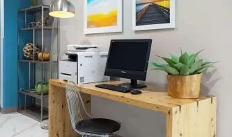 Business center with computer and printer at Days Inn By Wyndham Staten Island.