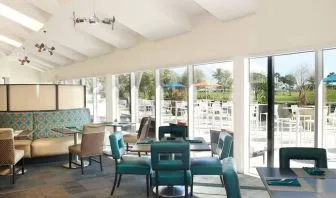 On-site restaurant with comfortable seating, perfect for co-working at Sheraton Miami Airport Hotel.