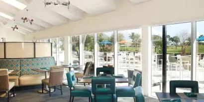 On-site restaurant with comfortable seating, perfect for co-working at Sheraton Miami Airport Hotel.