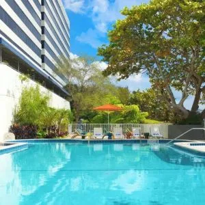 Outdoor pool with lounge chairs at Sheraton Miami Airport Hotel.