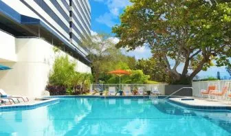 Outdoor pool with lounge chairs at Sheraton Miami Airport Hotel.
