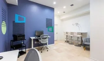 Business center with computers, printer and ergonomic chairs at Regency Miami Airport By Sonesta.