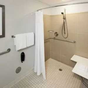 Private guest bathroom with accesible shower and free toiletries at Courtyard Miami Dolphin Mall.