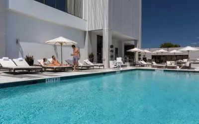 Outdoor pool with lounge chairs at EB Hotel Miami.