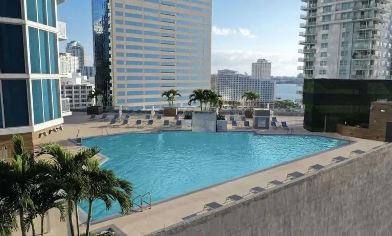Rooftop pool with lounge chairs at Hyatt Centric Brickell Miami.