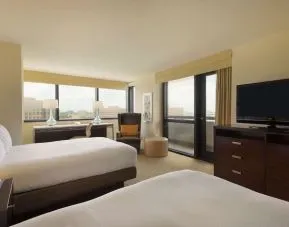 Day use twin room with work desk, balcony and private bathroom at Hilton Miami Airport Blue Lagoon.