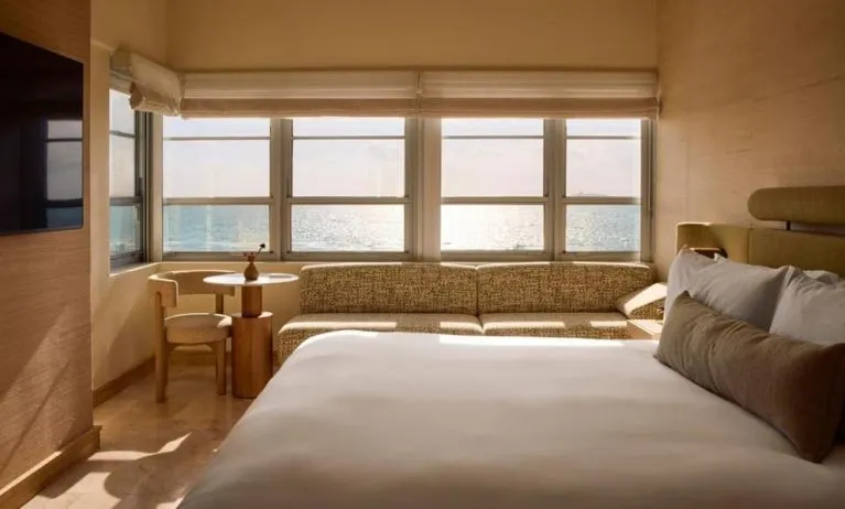 Day use room with king bed, large windows, lounge area and private bathroom at Shelborne South Beach.
