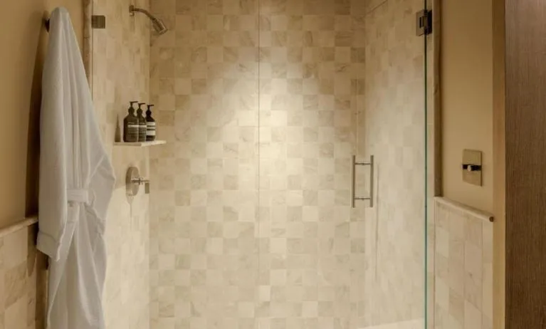 Private guest bathroom with shower and free toiletries at Shelborne South Beach.