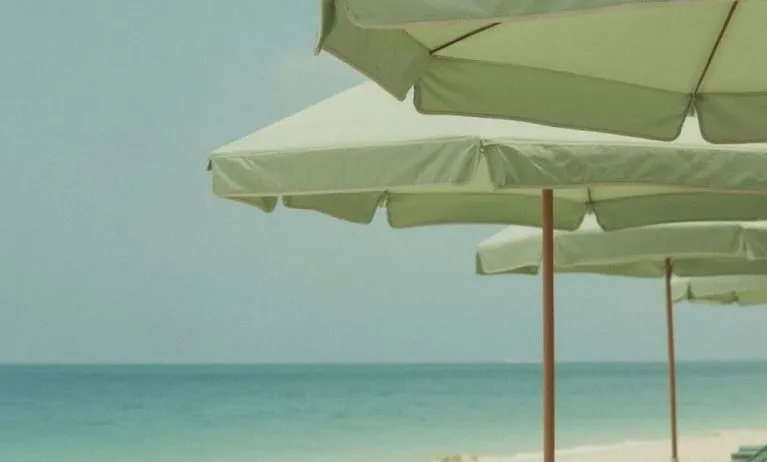 Private beach access with lounge seating and umbrellas at Shelborne South Beach.