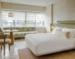 Day use room with lounge and workspace area and private bathroom at Shelborne South Beach.