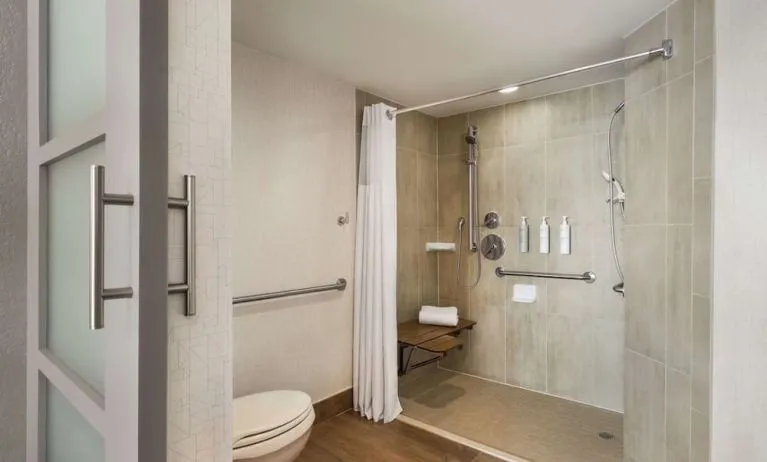 Private guest bathroom with shower and free toiletries at Embassy Suites By Hilton Miami - International Airport.