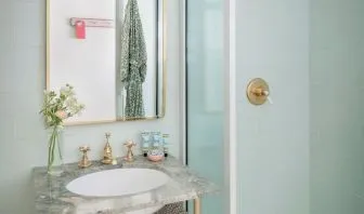 Private bathroom with shower and free toiletries at The Goodtime Hotel.
