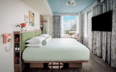 Day use room with king bed, TV screen, large windows and private bathroom at The Goodtime Hotel.