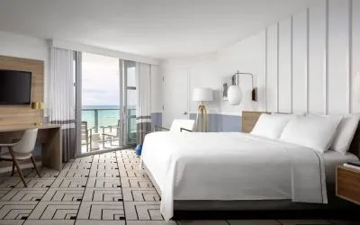 Day use room with king bed, work desk, balcony and private bathroom at Cadillac Hotel & Beach Club, Autograph Collection.