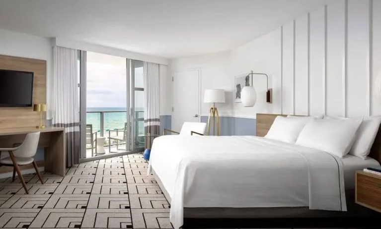 Day use room with king bed, work desk, balcony and private bathroom at Cadillac Hotel & Beach Club, Autograph Collection.