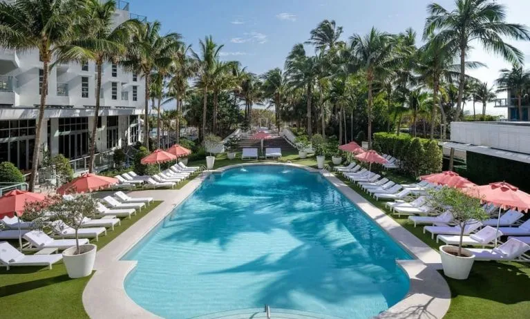 Beautiful outdoor pool with lounge chairs at Cadillac Hotel & Beach Club, Autograph Collection.