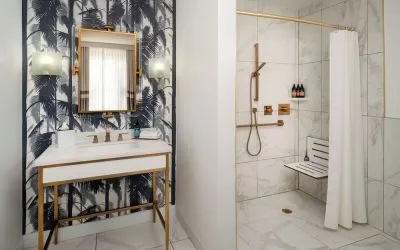 Accessible private guest bathroom with shower at Cadillac Hotel & Beach Club, Autograph Collection.