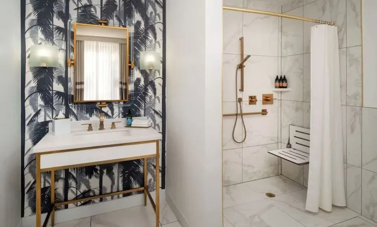 Accessible private guest bathroom with shower at Cadillac Hotel & Beach Club, Autograph Collection.